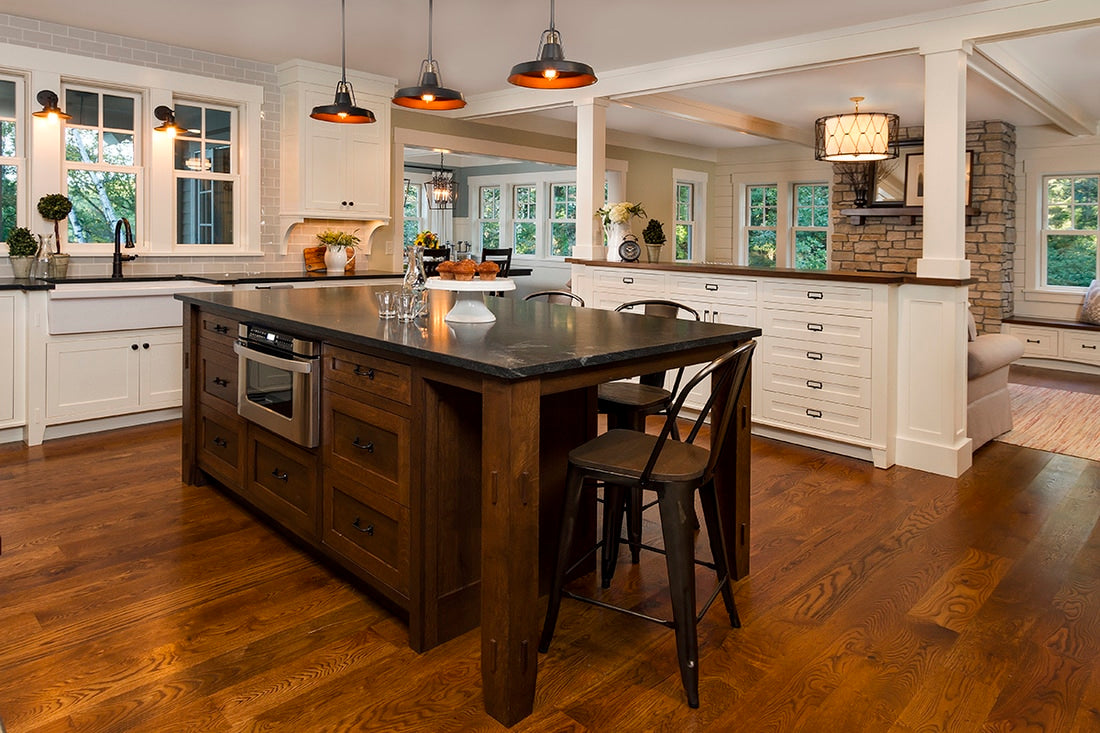Wide view of a custom kitchen with a farmhouse sink.